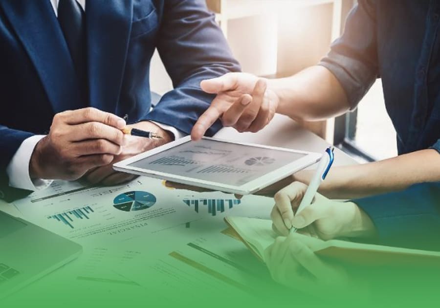 mcashadvance-invest-in-mca financial data on an iPad screen and financial documents on an office desk being reviewed by a person and an investor