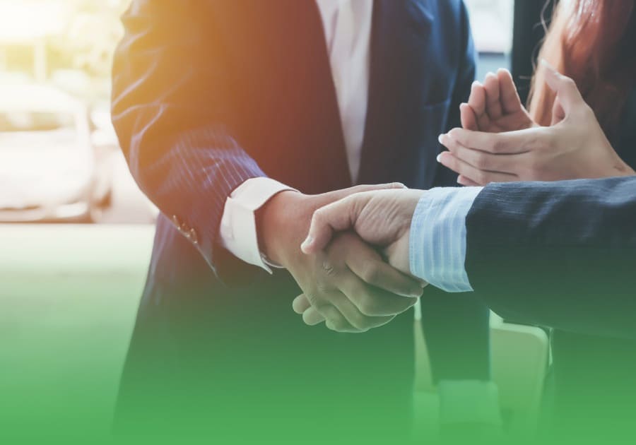 mcashadvance-investors two business investors in shaking hands and a business woman clapping
